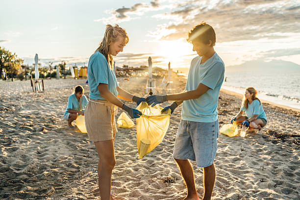 istock Volunteers cleaning the sea beach 2207983842
