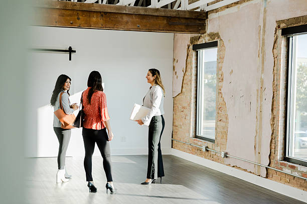 istock Three Women Discussing Business in a Modern Office Space 2207983999