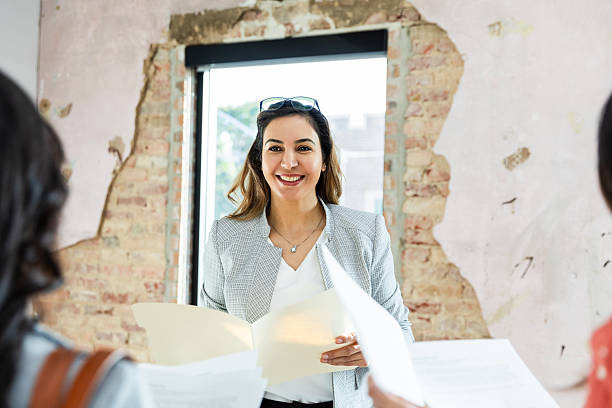 istock Confident businesswoman explaining business plan to colleagues 2207984013