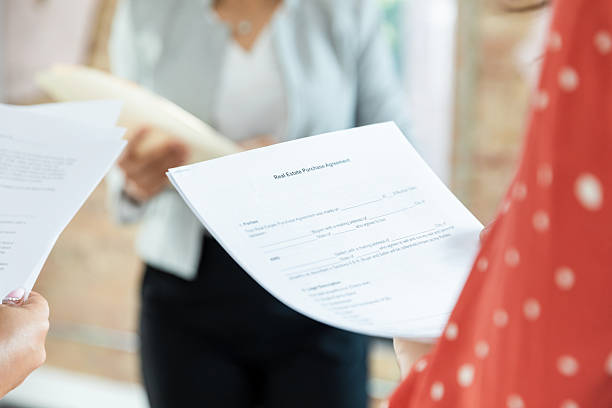 istock Real Estate Purchase Agreement: Two Women Reviewing Documents 2207984021
