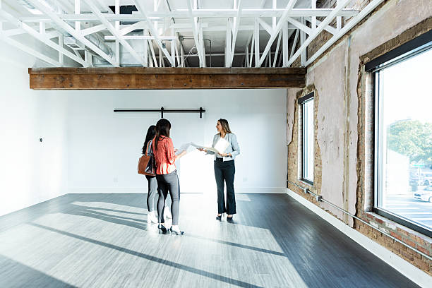 istock Three Businesswomen Discussing Plans in Empty Office Space 2207984023