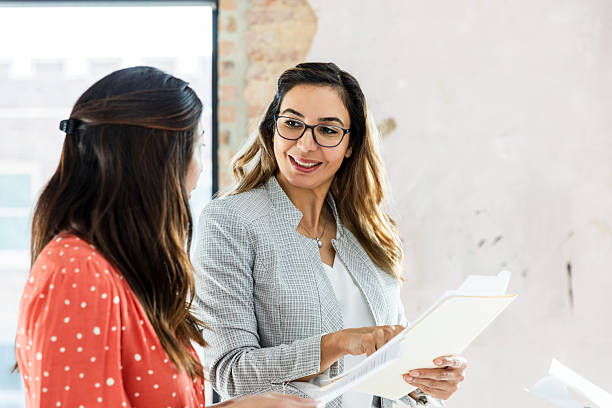 istock Two Women Discussing Business Documents in Office 2207984036