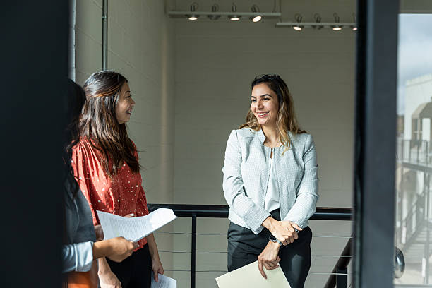 istock Three Businesswomen Discussing Plans in Office 2207984069