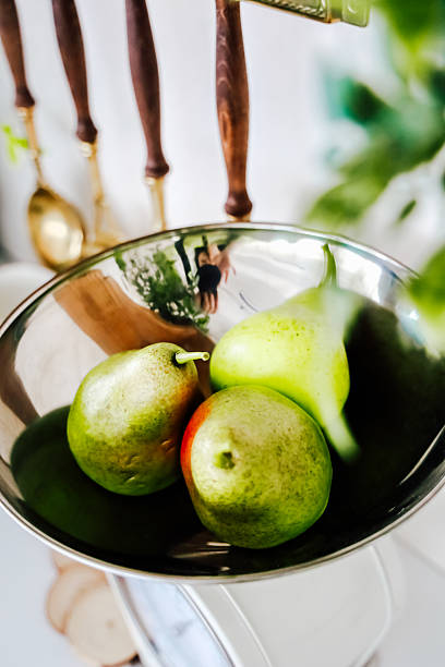 istock Fresh pears in a shiny bowl on a kitchen scale inside a bright home setting 2207984292