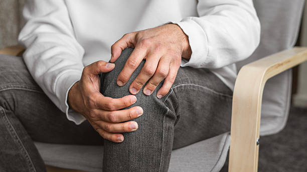 istock Man suffering from knee pain at home, closeup 2207985816