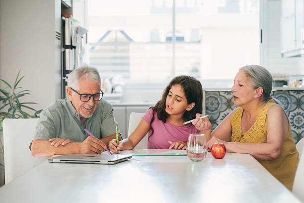 istock granddaughter doing homework with  grandparents 2207986198