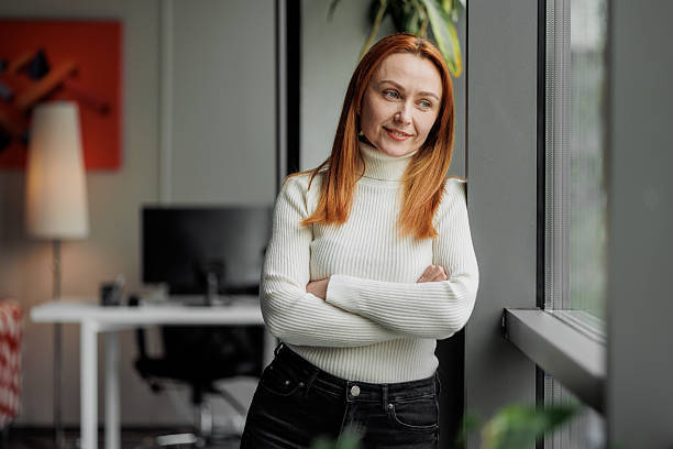 istock Woman in Modern Office by Window 2207987053