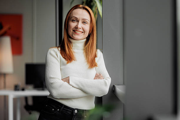 istock Smiling Woman in Modern Workplace 2207987071