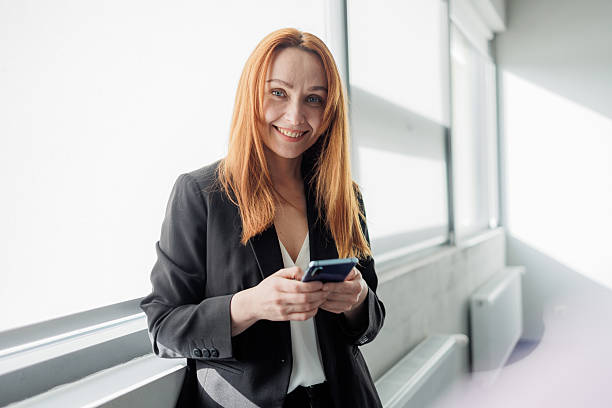 istock Businesswoman Using Smartphone in Modern Office 2207987142