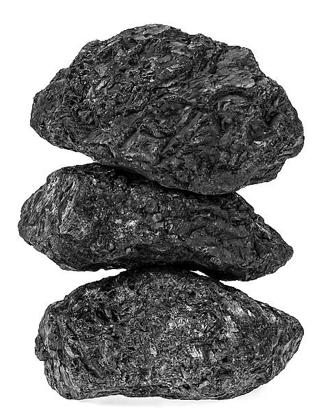 Large coal lumps isolated on a white background. Black coal pyramid.