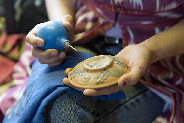 Artist paints a ceramic plate. Uzbekistan stock photo