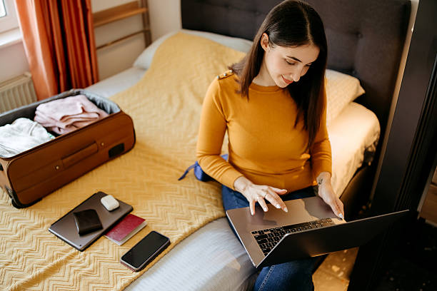 istock Woman making reservations online while preparing for a trip 2207989083