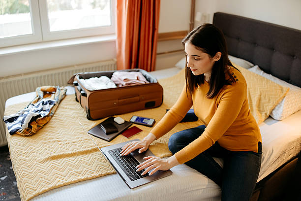 istock Woman making reservations online while preparing for a trip 2207989093