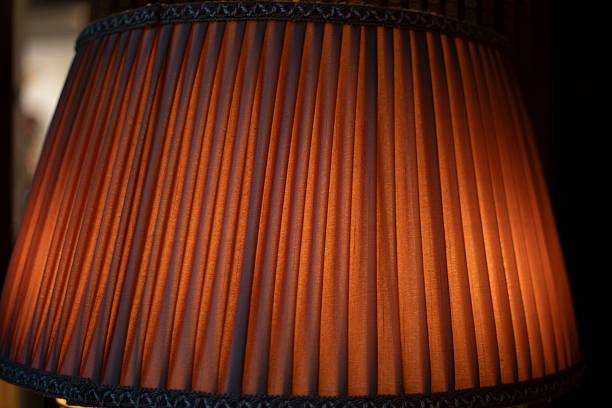 Light through fabric. Detail of an antique lamp. Dark texture in the interior.
