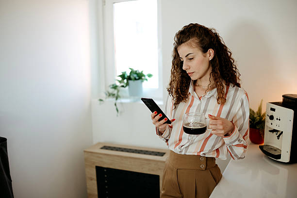 istock Happy woman with phone and coffee mug 2207990266