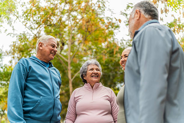 istock Senior friends talking on public park 2207991021