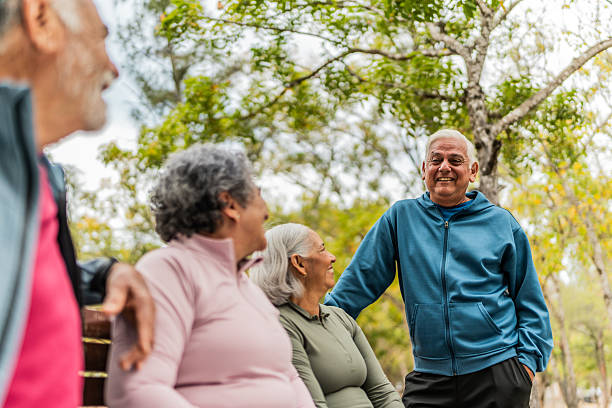 istock Senior friends talking on public park 2207991051