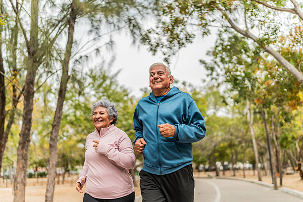 Senior couple talking and running on public park
