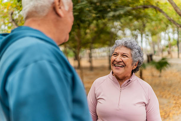 istock Senior woman talking to husband on public park 2207991111