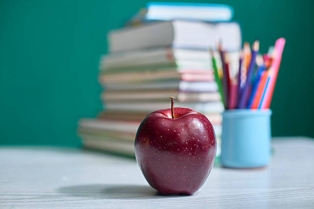 istock Red Apple on Desk with Books and Pencils 2207991551