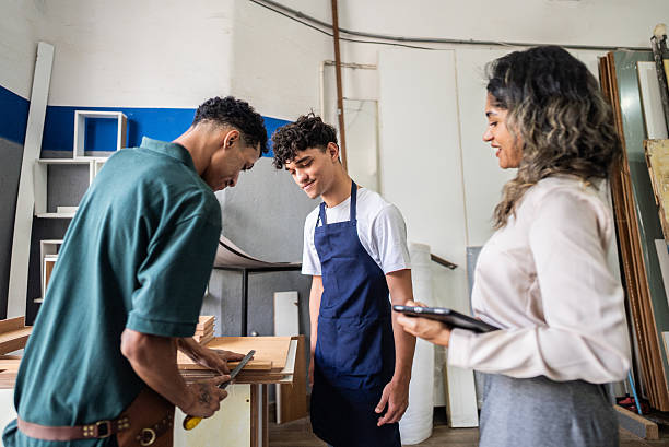 istock Trainee learning with his coworkers at the carpentry 2207991778