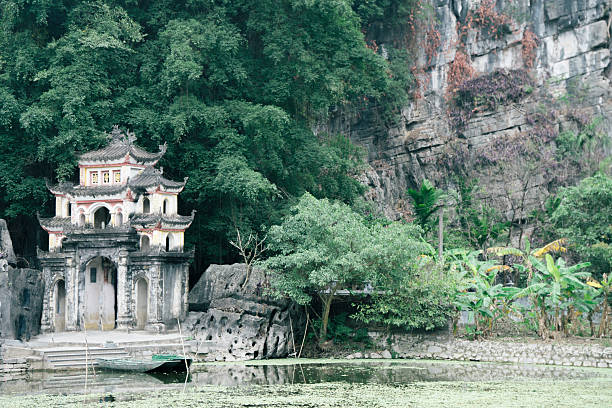 istock The structure of a building is visible, with lush trees behind it Ninh Binh, Vietnam 2207994066