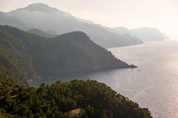 Misty Coastal Scene with Mountains and Sea
