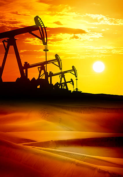 Sunset over drilling rig petroleum pump in the desert