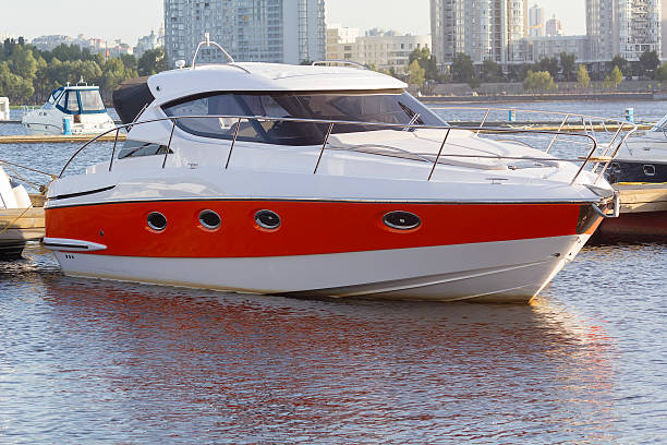 White and red modern yacht at the pier. Transport