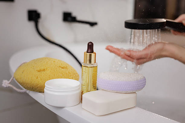 istock Spa essentials and shower water flowing over hand, modern bathroom self-care skincare routine. 2208001666