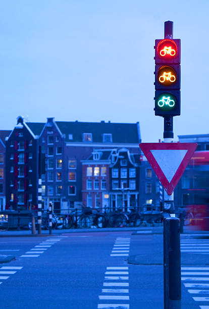 Reflection Of Bicycle Stoplight On Glass With Defocused Lights In Background