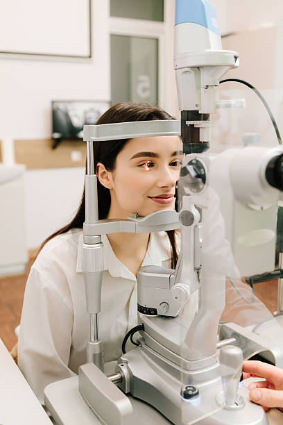 istock Slit lamp eye and cornea diagnostic at visiting ophthalmology clinic. Light on eye from slit lamp for examination eyes and cornea of girl. 2208005087