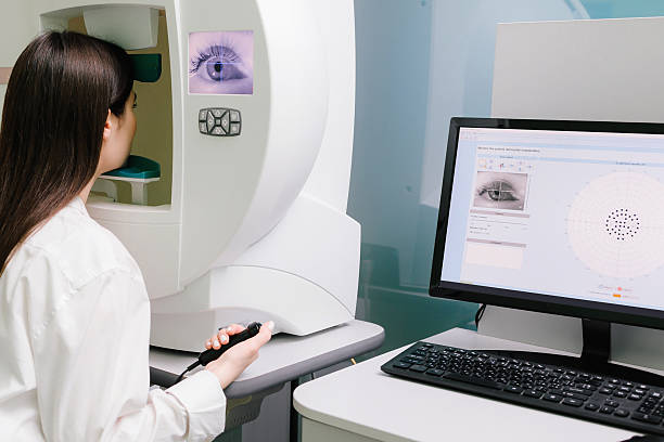 istock Perimetry visual field test for measure all areas of eyesight, including side, or peripheral vision. Perimetry eyes test for early sign of glaucoma of woman patient of ophthalmology clinic. 2208005257