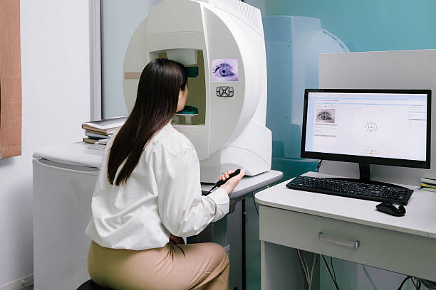 istock Perimetry visual field test for measure all areas of eyesight, including side, or peripheral vision. Perimetry eyes test for early sign of glaucoma of woman patient of ophthalmology clinic. 2208005264