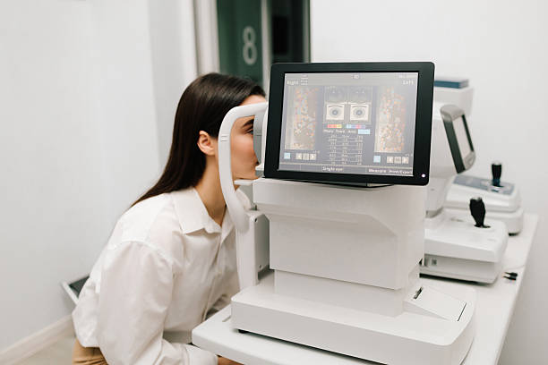 Girl undergoes an OCT eye exam using advanced optical coherence tomography equipment. The high-resolution display shows retinal scans, assisting in early diagnosis of eye diseases.