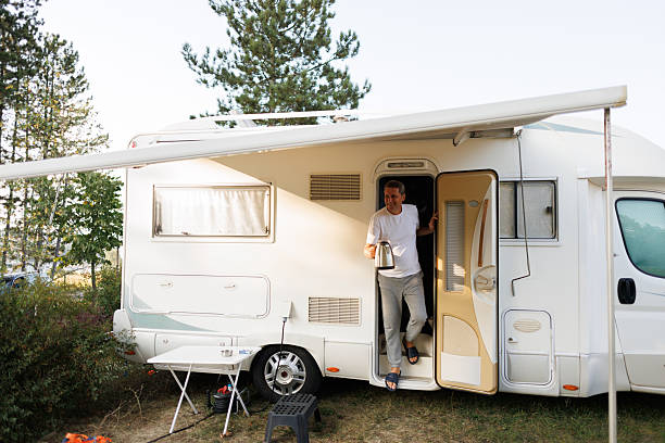 istock Smiling Man Making Morning Tea Outside RV 2208005824