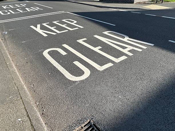 istock White road markings painted on asphalt road surface 