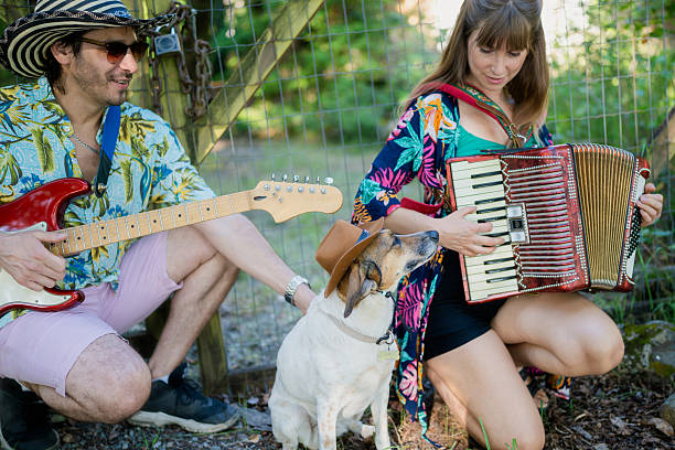 istock Musicians playing music with their dog in a countryside setting 2208006648
