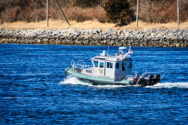 Sandwich, Massachusetts, USA -February 26, 2025- A Massachusetts Environmental Police Boat heads west on the Cape Cod canal on a February afternoon. They, along with the U.S. Army Corps of Engineers patrol the Cape Cod Canal