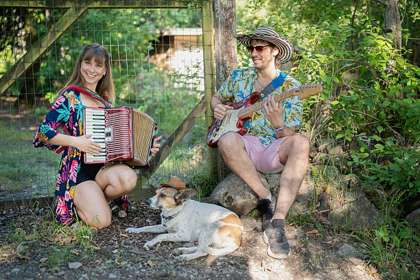 istock Musicians playing accordion and guitar outdoors with dog 2208007387