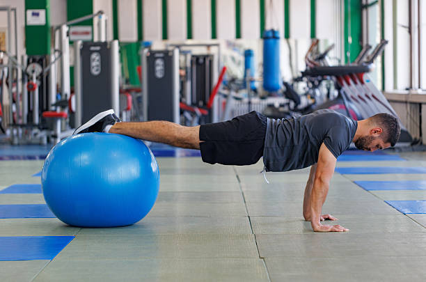 istock Athletic Man Performing Stability Push-Ups on Gym Ball 2208007641