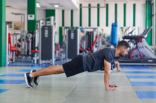 istock Young Sportsman Training with Push-Ups Indoors 2208007651