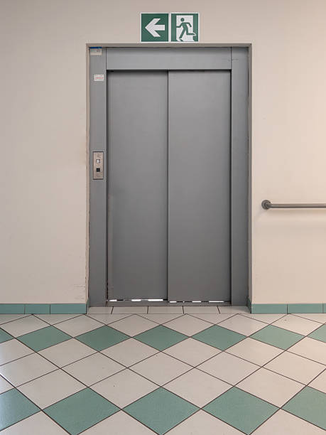istock Elevator door to floor with green and white square tile floor 2208007922