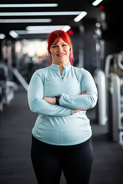istock Smiling Woman Posing with Arms Crossed 2208011378
