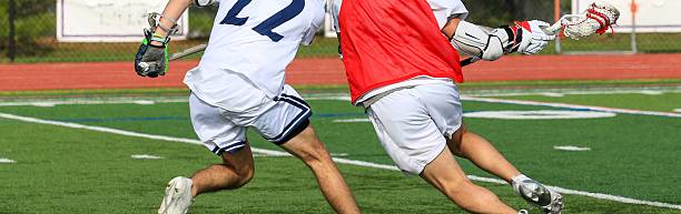 istock Competitive Youth Lacrosse Players Engage in a Fast-Paced Match 2208012680