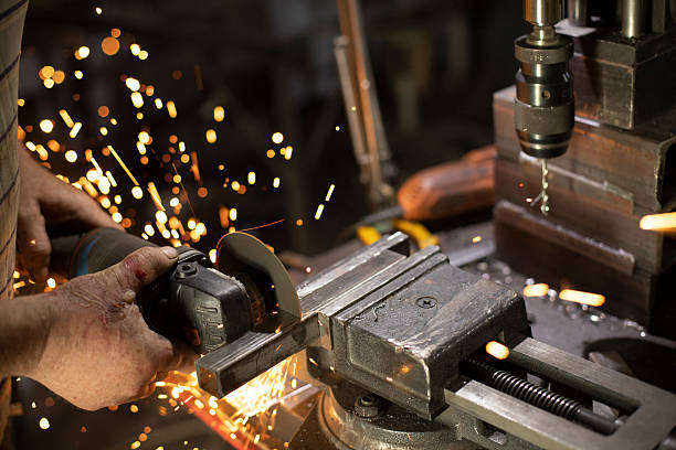 istock Metal sawing. Work in garage. Sparks from cutting steel. 2208017233