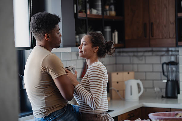 istock Young couple enjoying a lighthearted moment together in a cozy modern kitchen during breakfast time. 2208019072