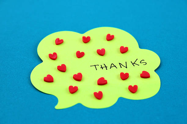 Comment bubble with the word thanks next to many hearts
