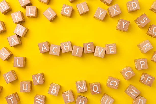 istock Block Words with Achieve on a Yellow Background 2208021854