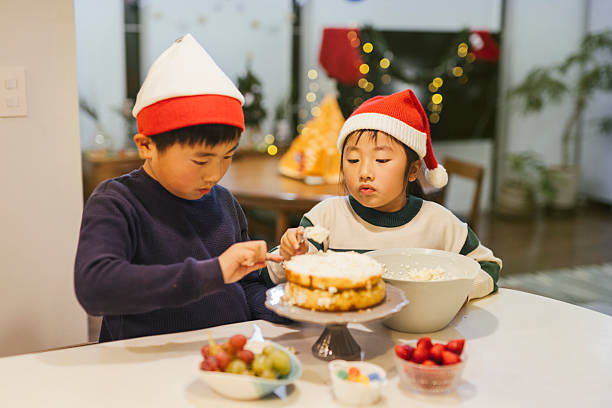 istock Asian sibling making a Christmas cake at home 2208023104